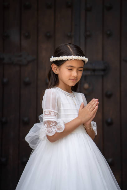 istock First Communion girl praying with eyes closes 1319151773