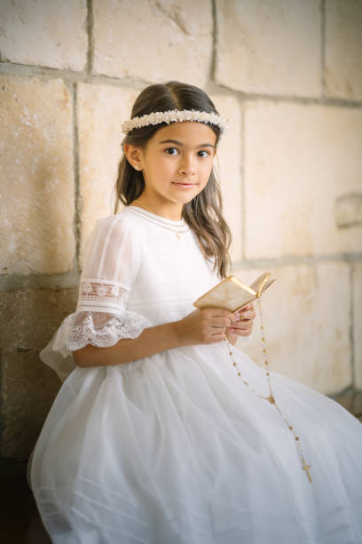 istock Little First Communion girl reading the bible 1319152390