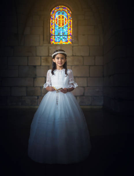 istock Cheerful First Communion girl reading the bible 1319152398