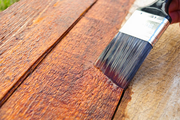 istock Outdoors Wood Surface Sealant Paintbrush Application Close-up 1319155992