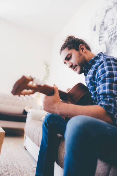 istock Simple Weekend Leisure at Home - Man Playing Guitar 1319162671