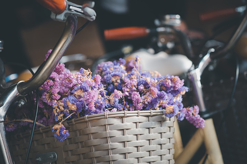 Bicycle with a basket of full flower. Close up
