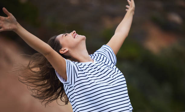 Shot of a young woman celebrating while out in nature Life is a gift waiting for you to receive it exhilaration stock pictures, royalty-free photos & images