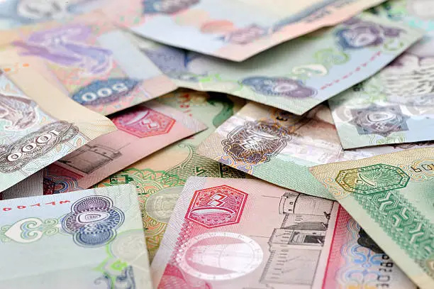 currency notes of uae in arabic print, image taken in dubai. concept image of financial matters