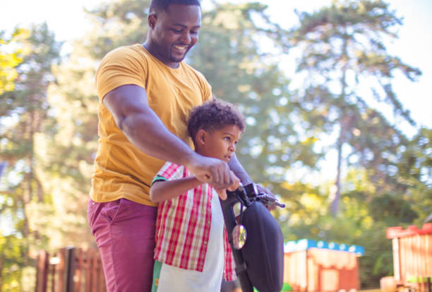 istock African American father having fun outdoors with his son. 1319167668