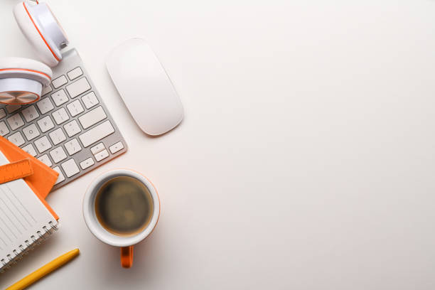 istock Top view of coffee cup, headphone, notebooks and keyboard on white table. 1319167721