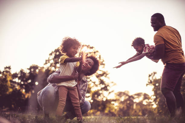 istock Happy African family playing in nature. 1319167736