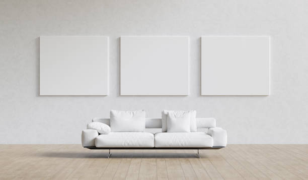 istock Large interior with three blank mockup canvases and white sofa. Presentation concept. 3D render. 1319169598