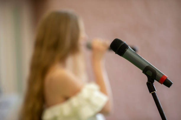istock Stage microphone on the background of the blurred singer. performance or recital. 1319170168