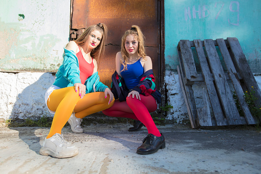 Funny girls in the style of the 90s in bright clothes.