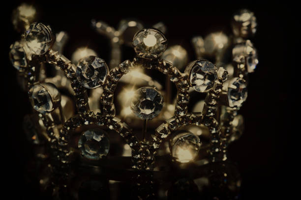 istock Gold crown with shiny stones on a black background. 1319170689