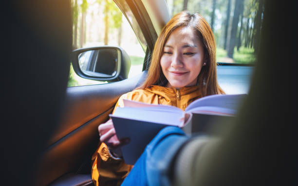 istock A young asian woman reading book while riding the car 1319172465
