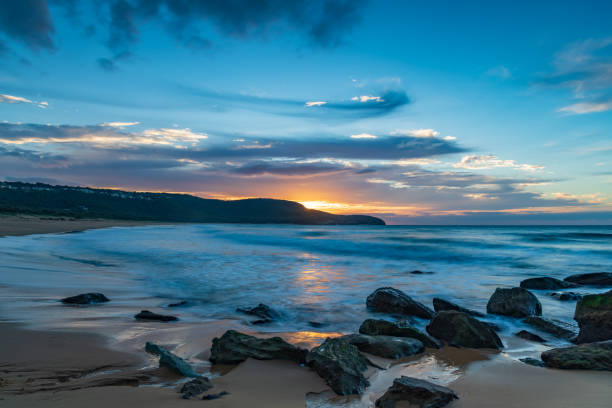 istock Sunrise at the seaside with pastel coloured clouds 1319172510