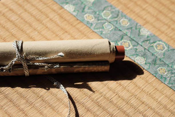 Cropped image hand of asian Chinese male practising Chinese calligraphy for Chinese new year celebration home decoration purpose with prosperity and good wording on a red piece of paper.