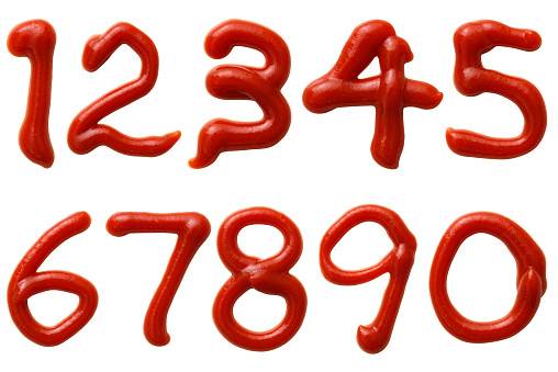 Overhead shot of numbers made of ketchup on white background.