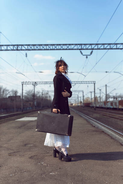 Young woman at the old train stop