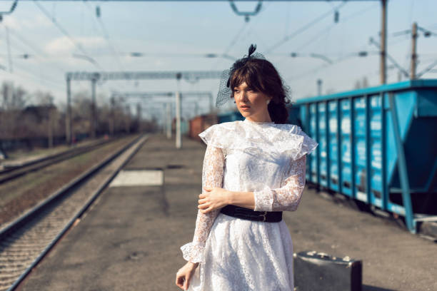 istock Young woman at the old train stop 1319179117