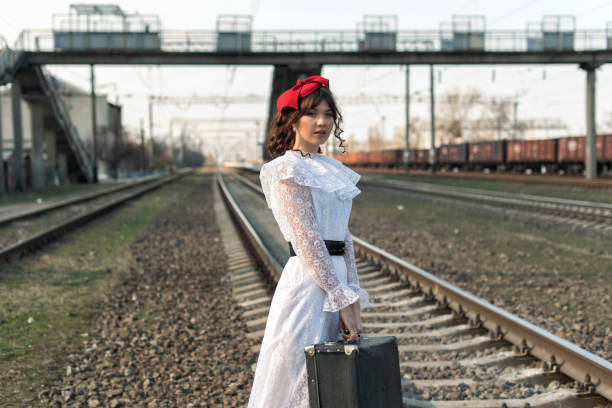 Young woman at the old train stop