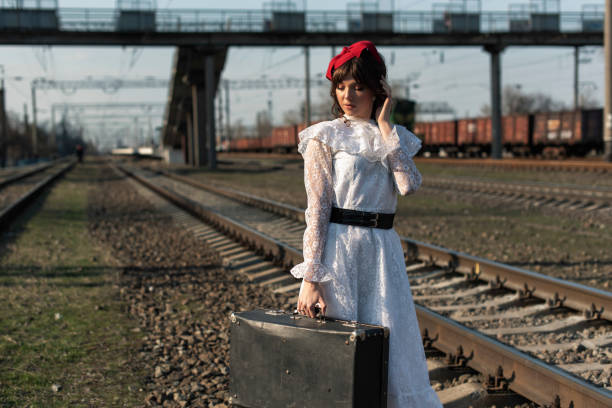 istock Young woman at the old train stop 1319179189