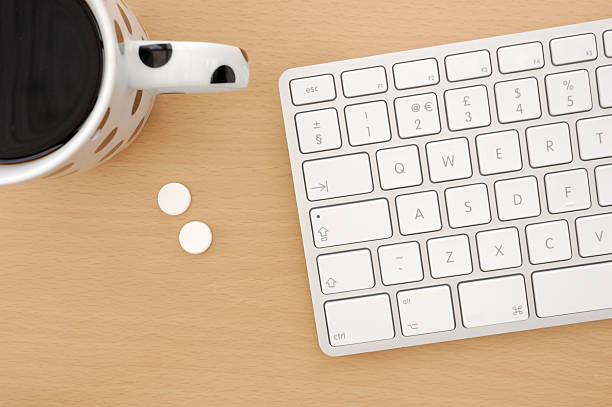 Pills and Coffee on Desk stock photo