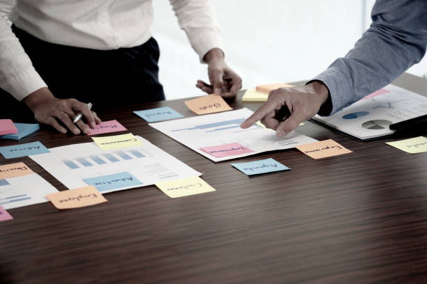 istock Two businessmen stand to consult with data graph chart paper 1319181234