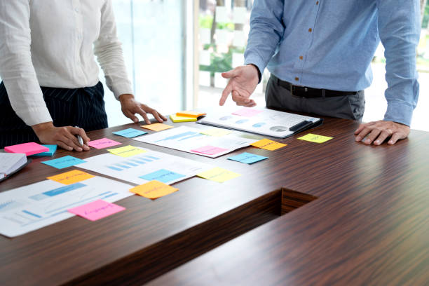 istock Two business people stand to consult with data graph chart paper 1319181242