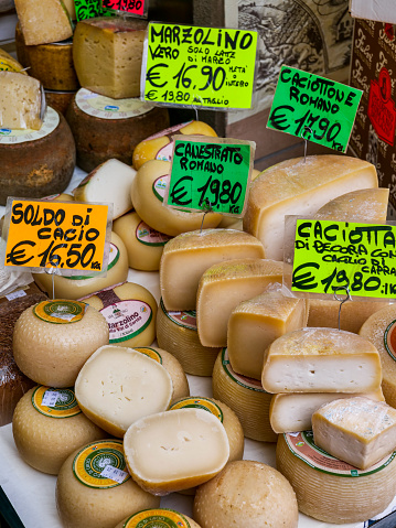 Rome, Italy, April 26 -- A typical gourmet shop in a local market in the Prati district in downtown Rome, close to the Vatican City area, with a great variety of famous Italian aged cheeses, caciotta and provola cheeses. Image in high definition format.