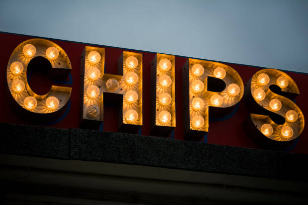 istock Illuminated sign at seaside fish and chip shop after dark 1319183504