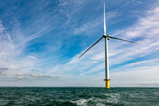 Offshore windfarm turbine and expanse of sea and sky View of the Rampion wind farm off the coast near Brighton offshore wind farm stock pictures, royalty-free photos & images