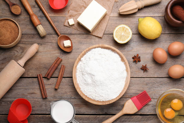 istock Cooking utensils and ingredients on wooden table, flat lay 1319187061