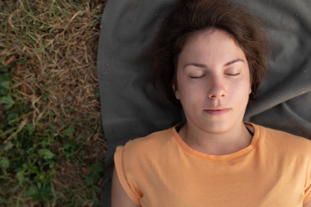istock Young woman lying on yoga mat 1319187087
