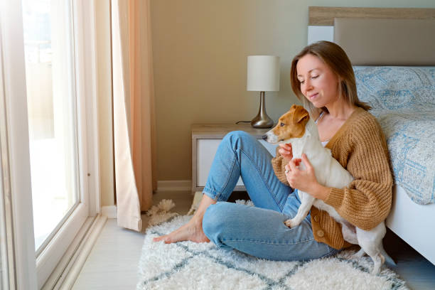 istock Woman at home with a dog 1319187125