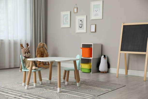 istock Child's room interior with stylish table, chairs and toys 1319187270
