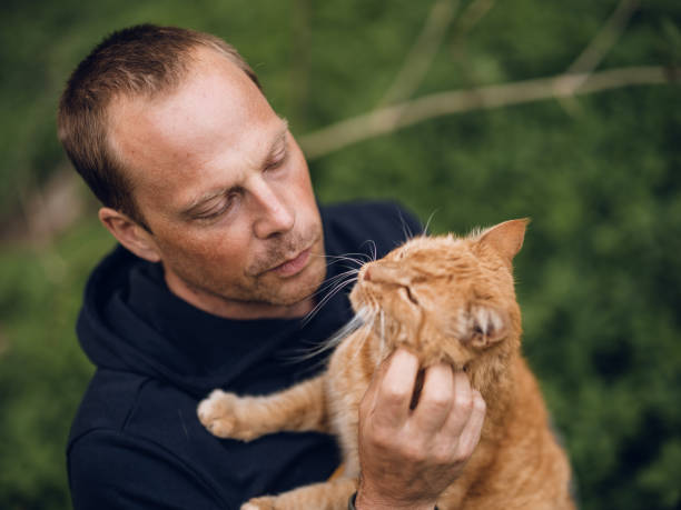 istock Real man outdoors with his cat in summer 1319187360