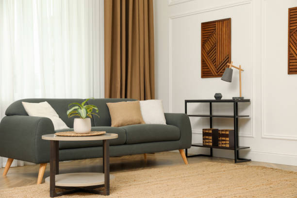 istock Beautiful sofa with cushions in living room. Interior design 1319187507