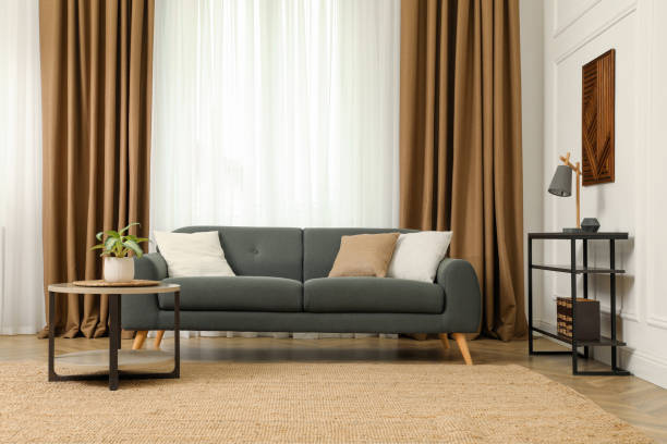 istock Beautiful sofa with cushions in living room. Interior design 1319188152