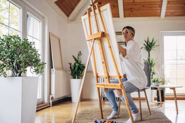 istock Beautiful woman painter at home 1319188339