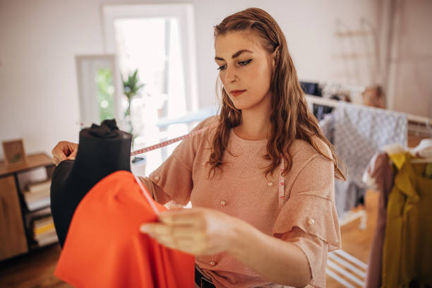 istock Female fashion designer taking measures 1319188458