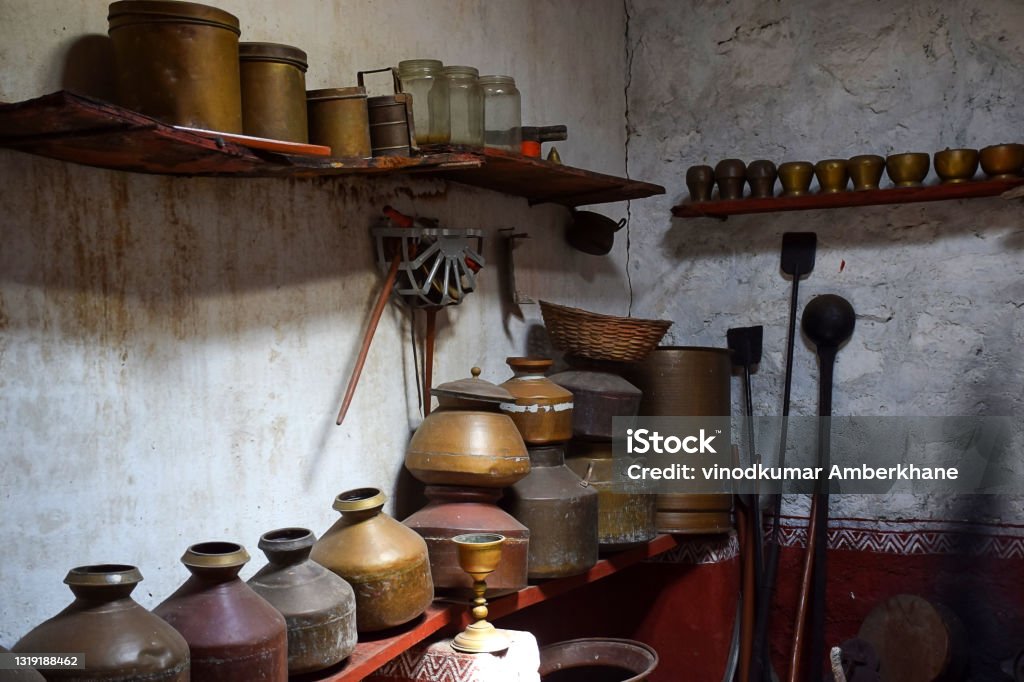 Stock photo of ancient or old copper metal utensils decorated and displayed in old Indian village . its shows Indian village culture. Ancient Stock Photo