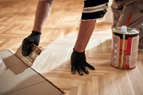istock Repairman restoring parquet with a sanding machine. 1319188490