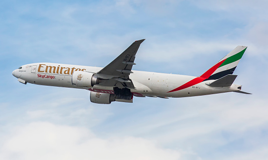 This image is of an Emirates Airlines Boeing 777F departing Hong Kong International Airport during covid times. Emirates SkyCargo is the air freight division of Emirates, which started operations in October 1985, the same year Emirates was formed. Since then it has been the main cargo division of Emirates, and the anchor cargo airline at Al Maktoum International Airport, its main hub. Emirates SkyCargo operates dedicated cargo flights to 26 destinations from Al Maktoum International Airport, and through the Emirates, passenger network has access to additional 61 destinations. Whilst using bellyhold capacity in the Emirates' passenger fleet, it also operates freighter aircraft. Emirates SkyCargo is a subsidiary of The Emirates Group, which has over 40,000 employees, and is wholly owned by the Government of Dubai directly under the Investment Corporation of Dubai. The company slogan is Delivering the highest standards of product quality.