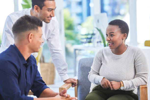 istock Shot of three businesspeople having a conversation in a modern office 1319188736