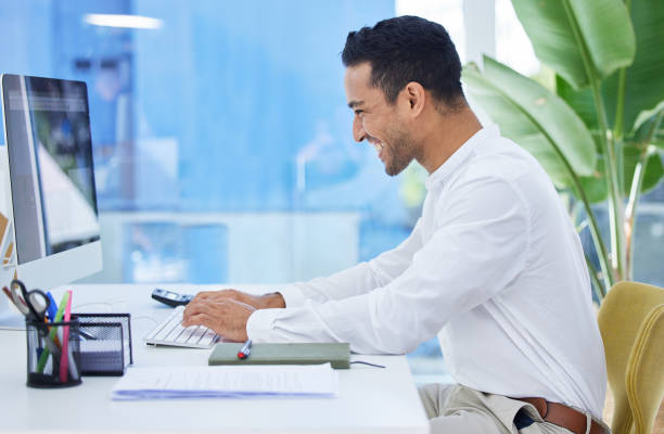 istock Shot of a young businessman using his computer while sitting at his desk 1319189301