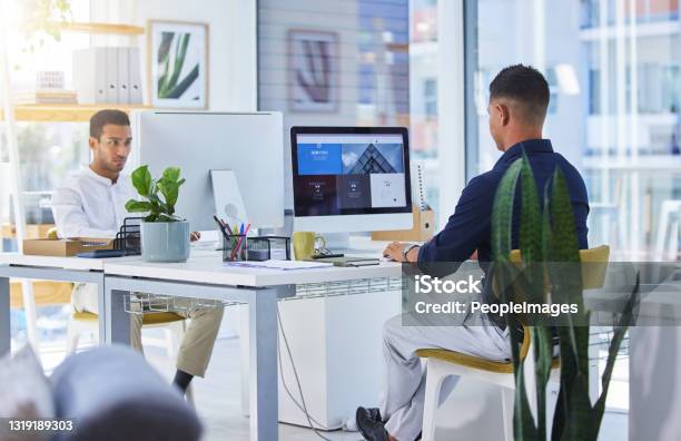 Shot Of Two Men Working On Their Computers In A Modern Office Stock Photo - Download Image Now