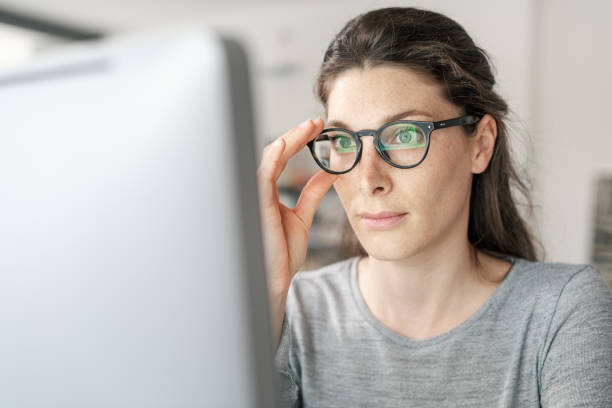 istock Woman with glasses working with a computer 1319189399
