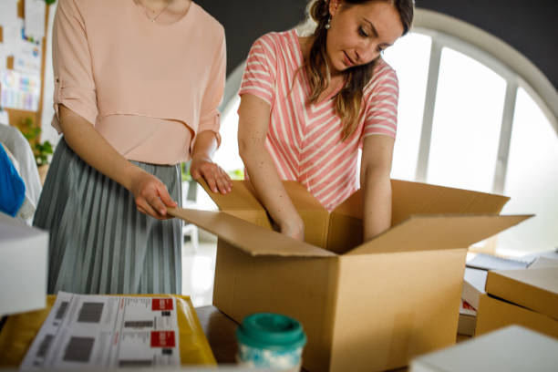 istock Two women preparing a box for charity 1319189755
