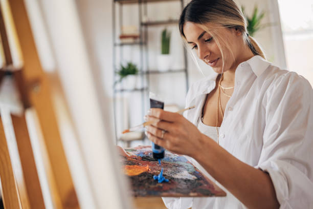 istock Beautiful woman painter at home 1319190609