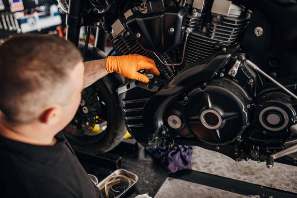 istock Male mechanic changing oil motorcycle 1319193016