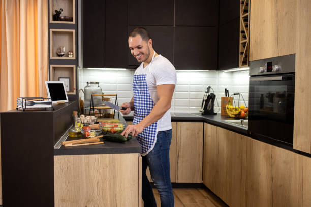 istock Handsome man in some home cooking action enjoying himself in the kitchen 1319195311