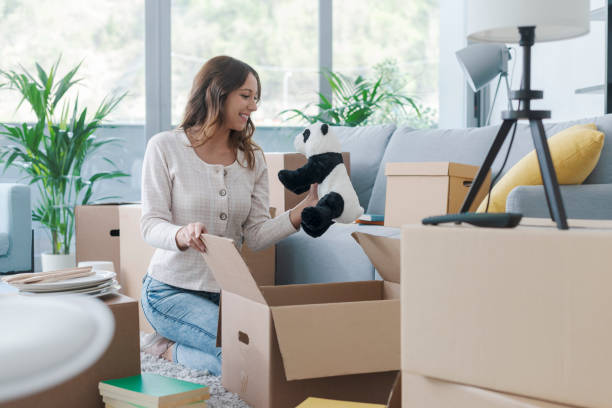 istock Woman unpacking in her new house 1319195861